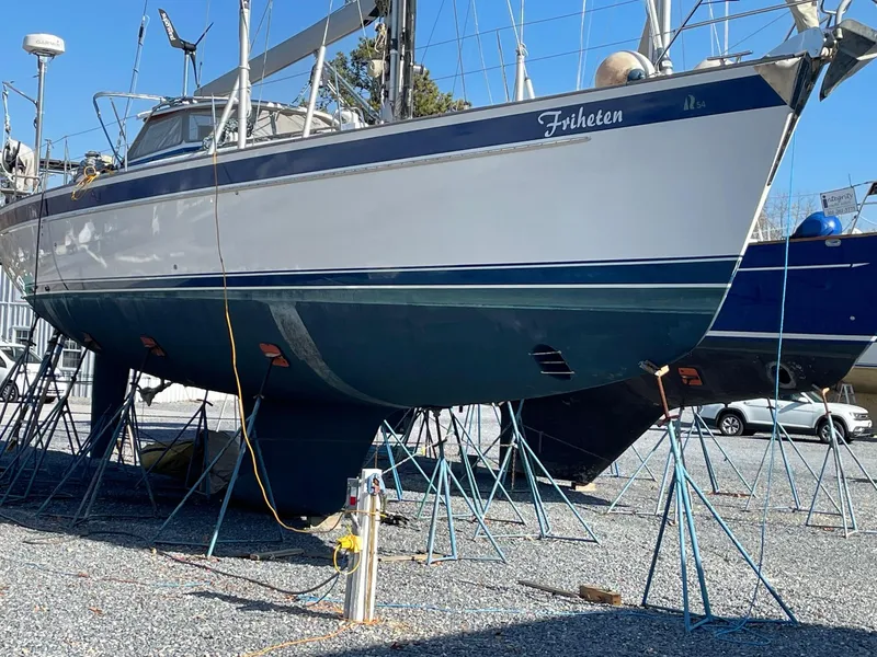 Slide: The Image of 2009 Hallberg-Rassy 54 sailboat on stands, displayed outdoors. - 41