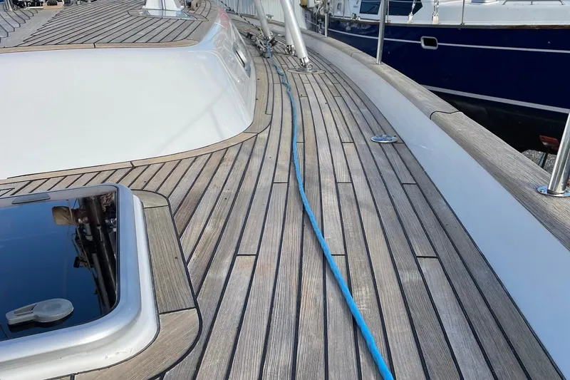 Slide: The Image of Teak deck of 2009 Hallberg-Rassy 54 yacht with blue rope and sleek design. - 44