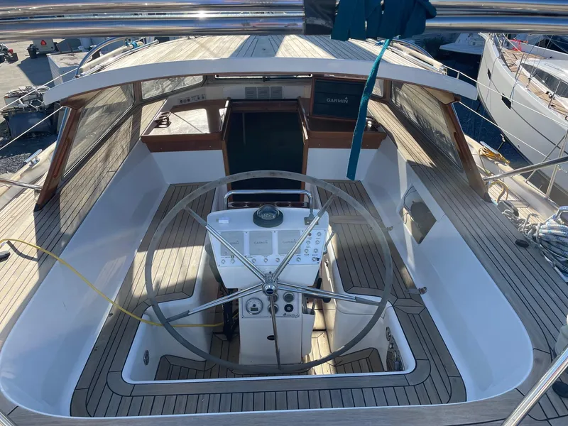 Slide: The Image of 2009 Hallberg-Rassy 54 yacht cockpit with steering wheel and navigation controls. - 6