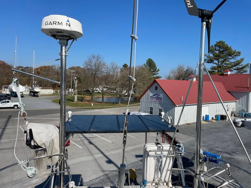 Slide: The Image of Hallberg-Rassy 54 sailboat, 2009 model, with Garmin equipment, docked near a marina building. - 8