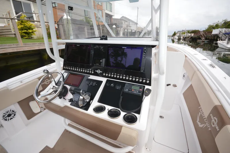 Slide: The Image of 2017 Fountain 38 Center Console boat cockpit with advanced navigation system. - 11