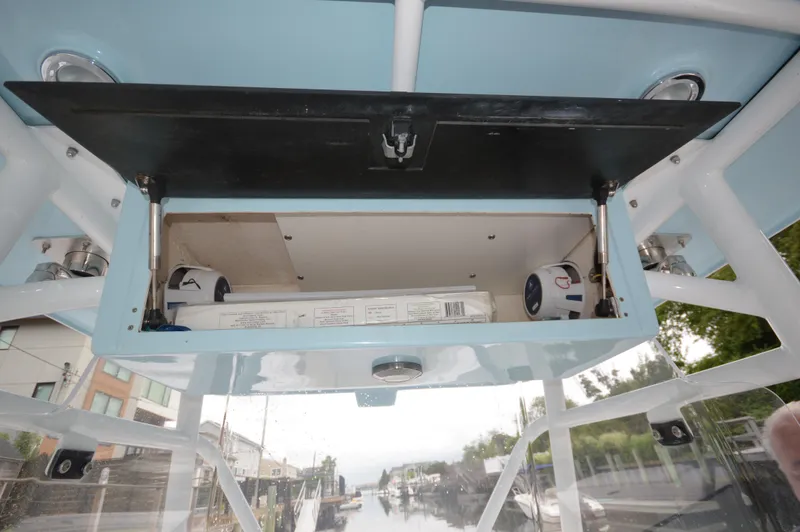Slide: The Image of Open storage compartment on a 2017 Fountain 38 Center Console boat. - 13