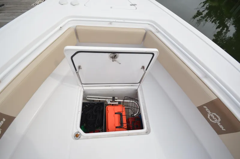 Slide: The Image of 2017 Fountain 38 Center Console storage compartment with safety equipment. - 17