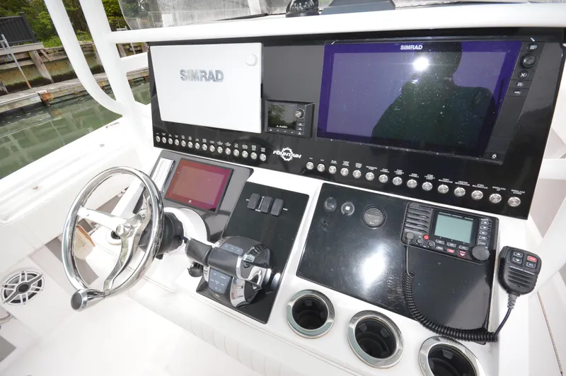 Slide: The Image of Control panel of a 2017 Fountain 38 Center Console boat with advanced navigation systems. - 21