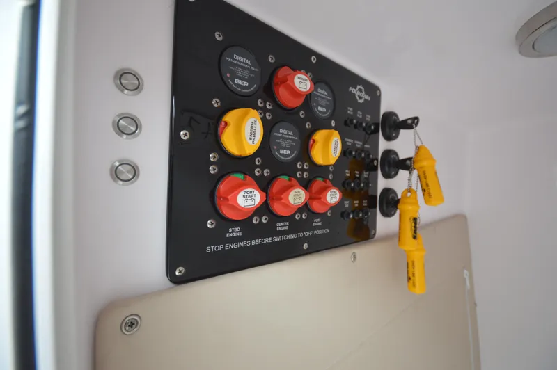 Slide: The Image of Control panel of a 2017 Fountain 38 Center Console boat with switches and safety keys. - 22