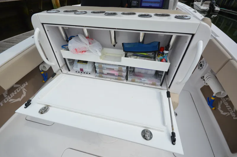 Slide: The Image of 2017 Fountain 38 Center Console boat with open storage compartment. - 26
