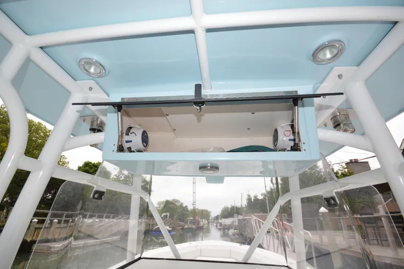 Slide: The Image of 2017 Fountain 38 Center Console boat interior with overhead storage and speakers. - 27