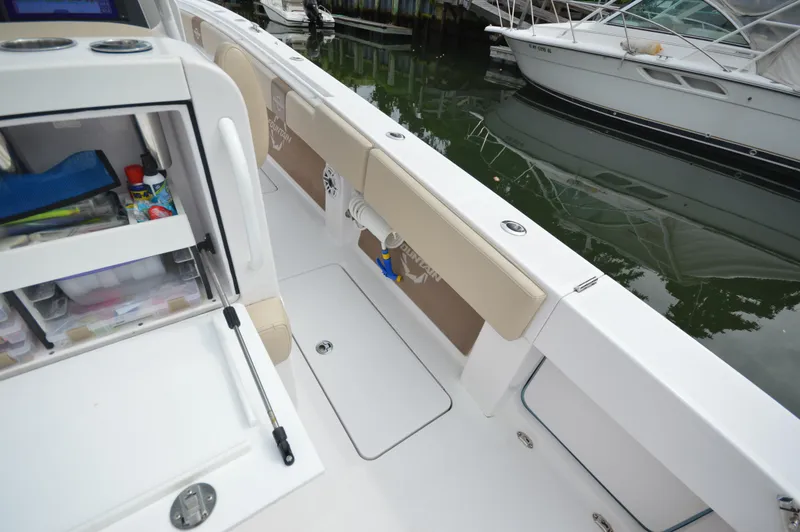 Slide: The Image of 2017 Fountain 38 Center Console boat interior with storage compartments and fishing gear. - 28