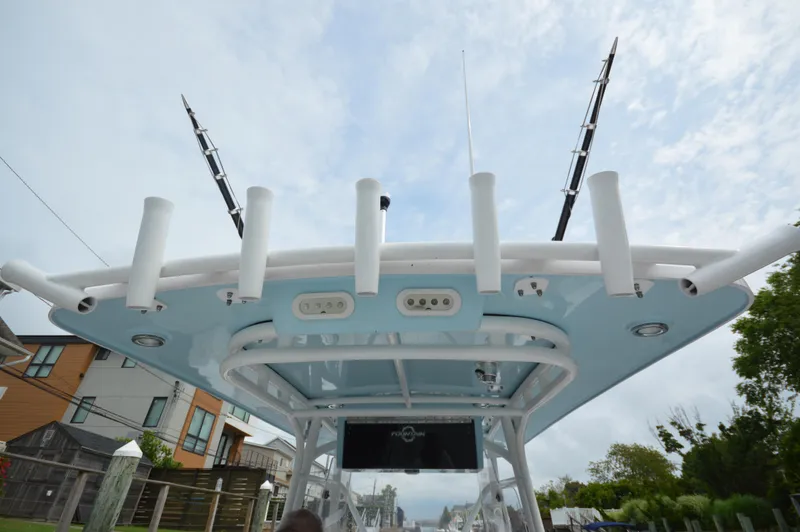 Slide: The Image of 2017 Fountain 38 Center Console boat with fishing rod holders and electronics. - 29