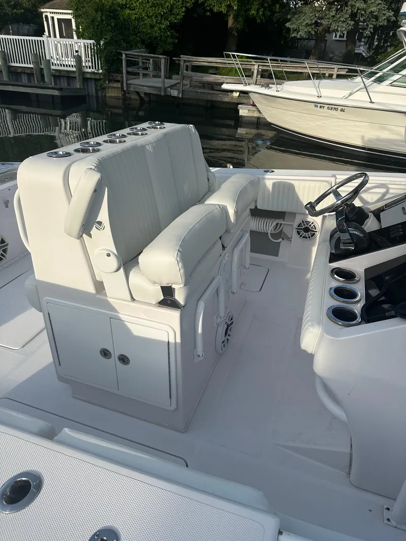 Slide: The Image of 2017 Fountain 38 Center Console boat interior with white seating and control panel. - 33