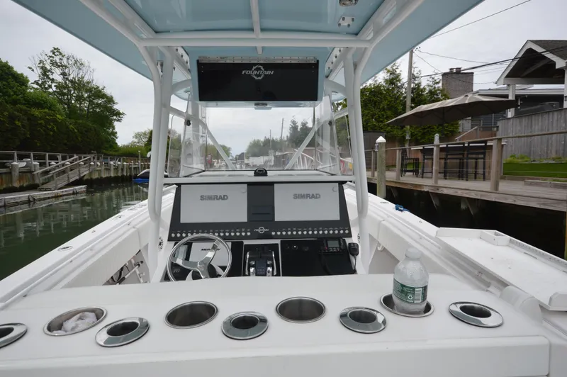 Slide: The Image of 2017 Fountain 38 Center Console boat interior with navigation equipment and cup holders. - 35