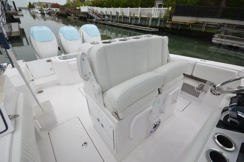 Slide: The Image of 2017 Fountain 38 Center Console boat with triple engines, docked in a marina. - 37