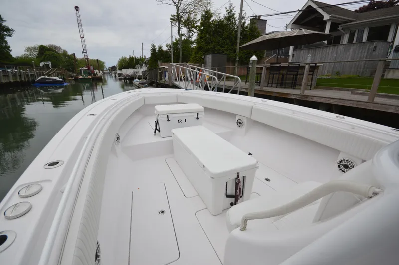 Slide: The Image of 2017 Fountain 38 Center Console boat docked in a serene canal setting. - 39