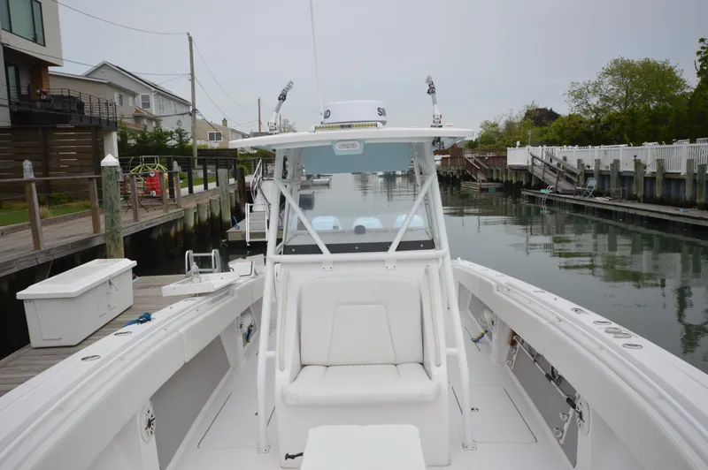 Slide: The Image of 2017 Fountain 38 Center Console boat docked in a serene marina setting. - 40