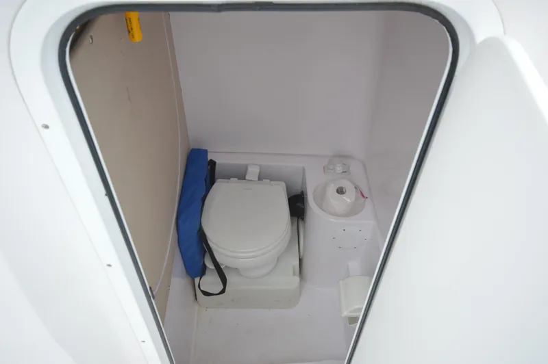 Slide: The Image of 2017 Fountain 38 Center Console boat bathroom with toilet and toilet paper holder. - 41