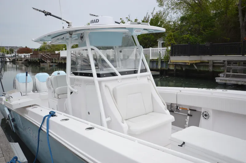 Slide: The Image of 2017 Fountain 38 Center Console boat docked, featuring sleek design and spacious seating. - 6