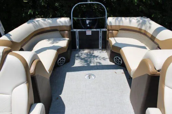 Slide: The Image of 2022 Lowe SS270 pontoon boat interior with beige and brown seating. - 5