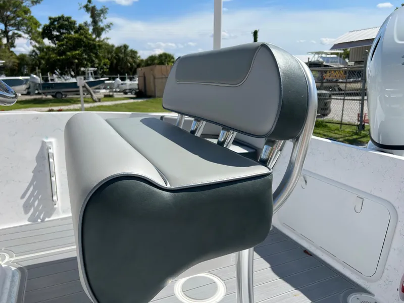 Slide: The Image of 2024 ALK2 Powerboats 18 CRS bench seat, gray and white upholstery, outdoor setting. - 12