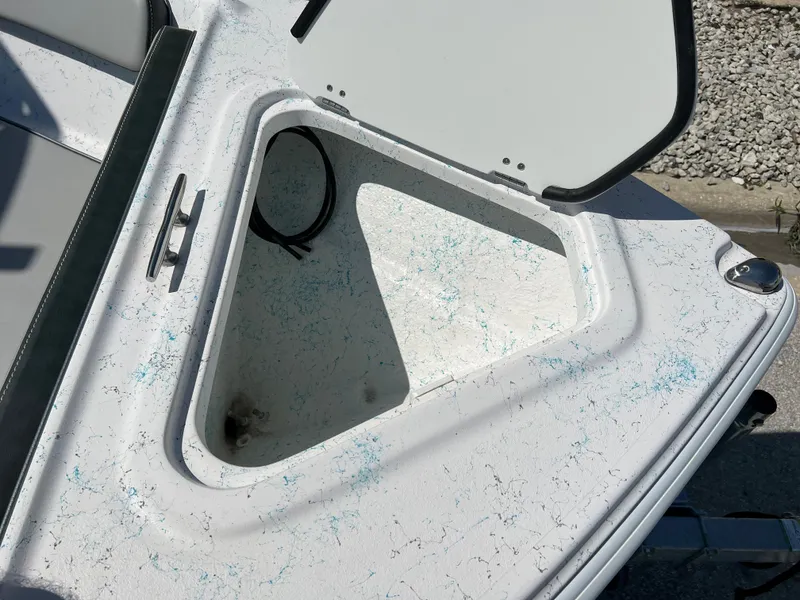Slide: The Image of Open storage compartment on 2024 ALK2 Powerboats 18 CRS, white interior with blue speckles. - 28