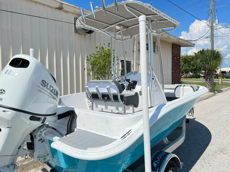 Slide: The Image of 2024 ALK2 Powerboats 18 CRS with Suzuki outboard motor, docked near a building. - 5