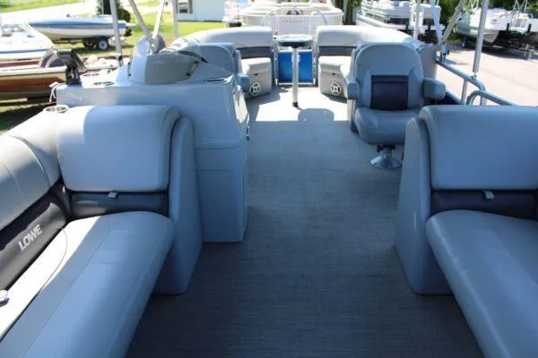 Slide: The Image of 2021 Lowe SS250 Super Sport pontoon boat interior with gray seating and helm station. - 4