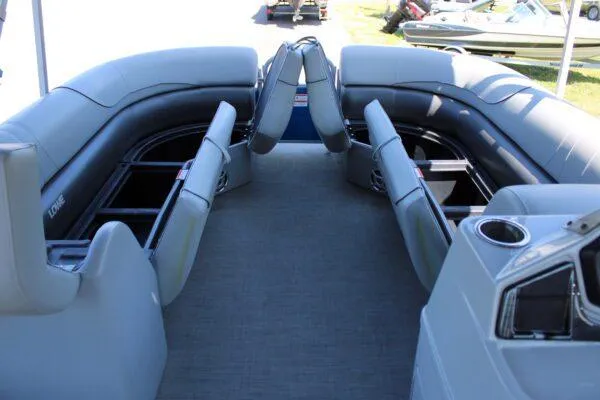 Slide: The Image of 2021 Lowe SS250 Super Sport pontoon boat interior with spacious seating and storage compartments. - 8