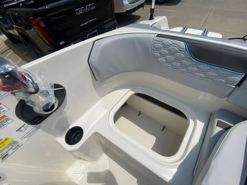 Slide: The Image of 2024 Bayliner Element M17 boat interior with storage compartment and cup holder. - 11