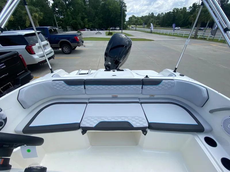 Slide: The Image of 2024 Bayliner Element M17 boat interior with cushioned seating and outboard motor. - 8