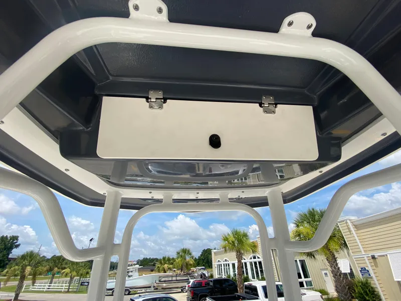 Slide: The Image of 2024 Robalo 226 Cayman T-top storage compartment, outdoor view. - 16