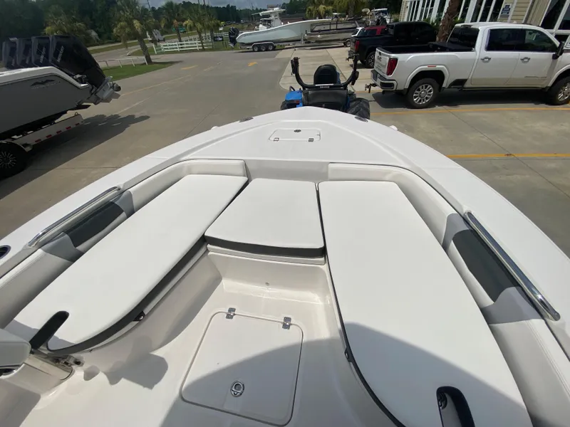 Slide: The Image of 2024 Robalo 226 Cayman boat interior with cushioned seating and storage compartments. - 18