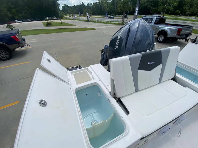 Slide: The Image of 2024 Robalo 226 Cayman boat with Yamaha engine, open storage compartments. - 8