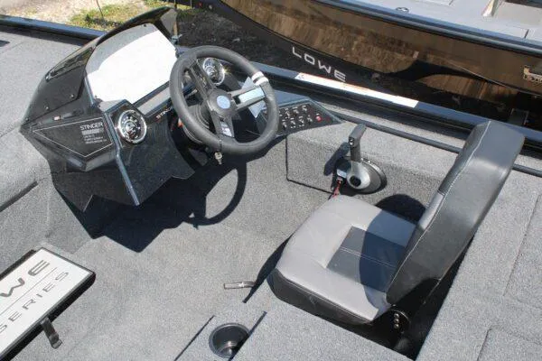 Slide: The Image of 2023 Lowe Stinger 178 boat cockpit with steering wheel and control panel. - 6