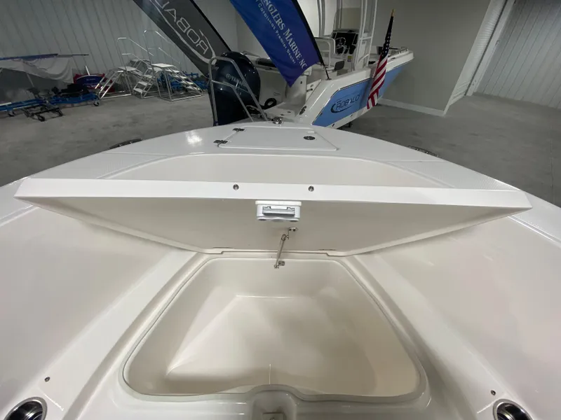 Slide: The Image of 2024 Robalo R180 Center Console boat with open storage compartment. - 17
