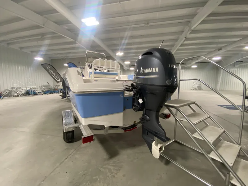 Slide: The Image of 2024 Robalo R180 Center Console boat with Yamaha outboard motor in a showroom. - 4