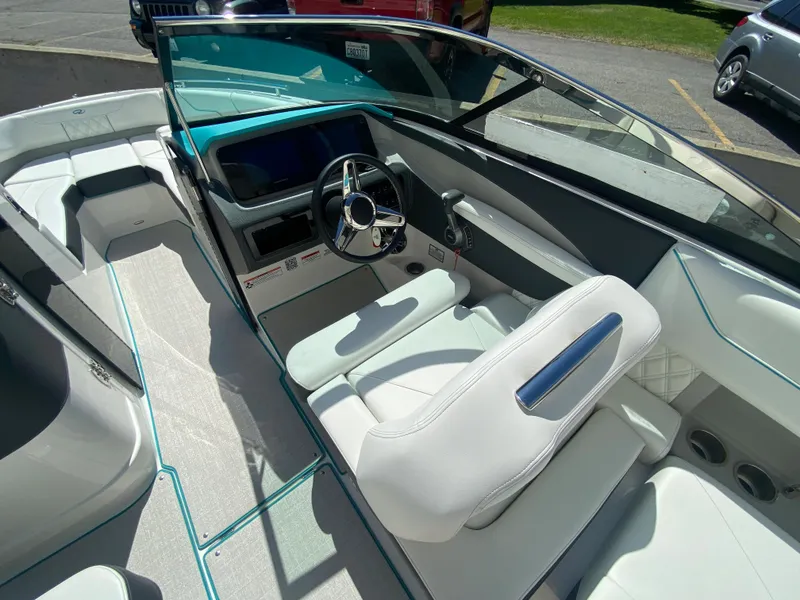 Slide: The Image of 2024 Regal LS6 boat interior with white seating and modern dashboard. - 10