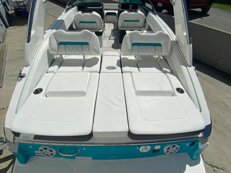 Slide: The Image of 2024 Regal LS6 boat with white and teal seating, rear view. - 14