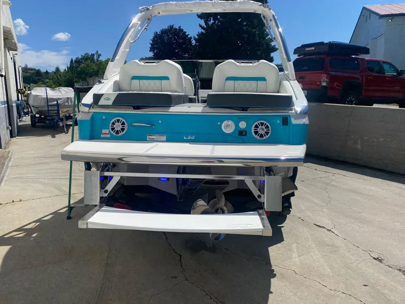 Slide: The Image of 2024 Regal LS6 boat, rear view, docked on concrete surface. - 16