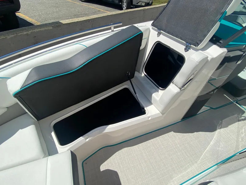 Slide: The Image of 2024 Regal LS6 boat interior with open storage compartments and cushioned seating. - 7