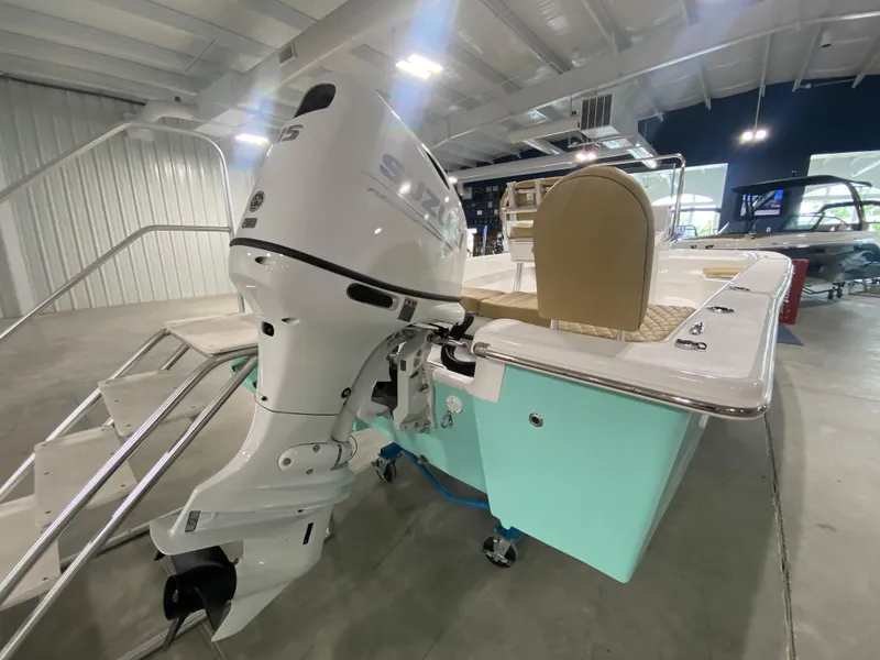 Slide: The Image of 2024 Savannah SS19 boat with outboard motor in showroom. - 4