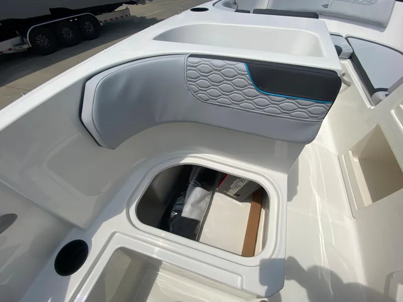 Slide: The Image of 2024 Bayliner Element M17 boat interior with storage compartment and cushioned seating. - 14