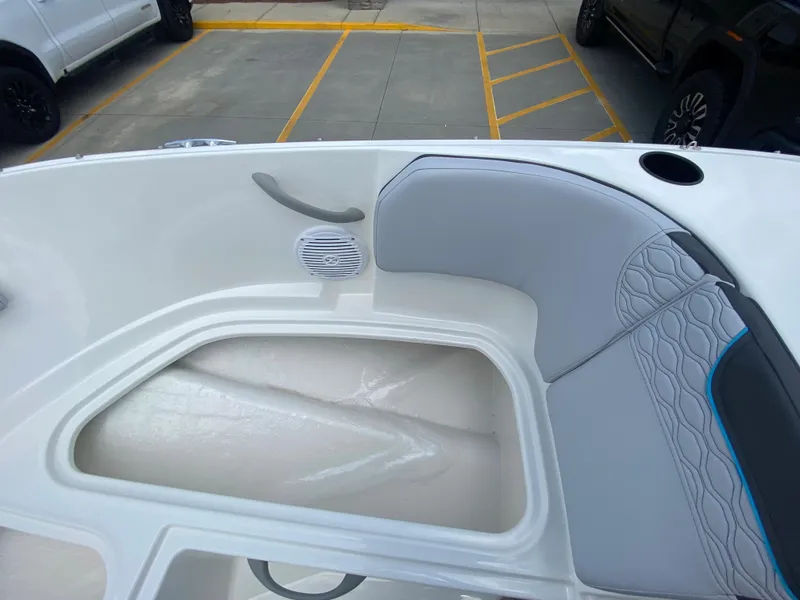 Slide: The Image of 2024 Bayliner Element M17 boat interior with gray seating and storage compartment. - 16