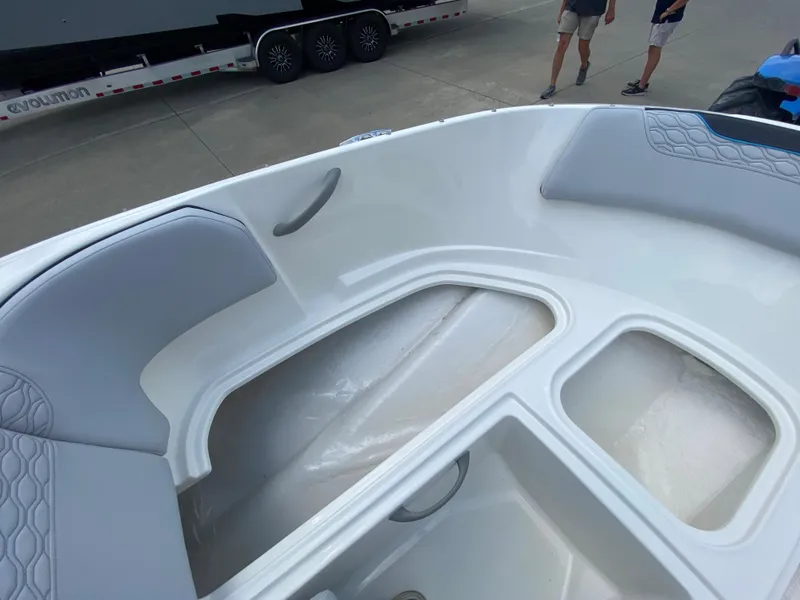 Slide: The Image of 2024 Bayliner Element M17 boat interior with seating and storage compartments. - 17