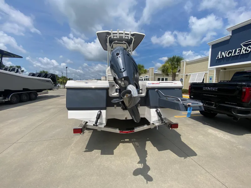 Slide: The Image of 2024 Robalo 226 Cayman boat rear view with outboard motor at dealership. - 4