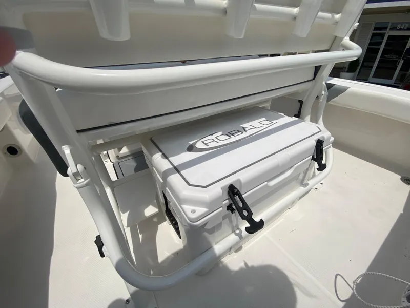 Slide: The Image of 2024 Robalo 226 Cayman boat with integrated cooler storage. - 9