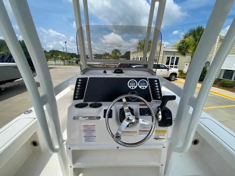 Slide: The Image of 2024 Robalo 226 Cayman boat console with steering wheel and controls. - 10