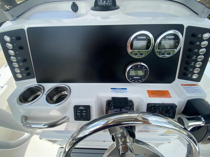 Slide: The Image of 2024 Robalo 226 Cayman boat dashboard with gauges and controls. - 12