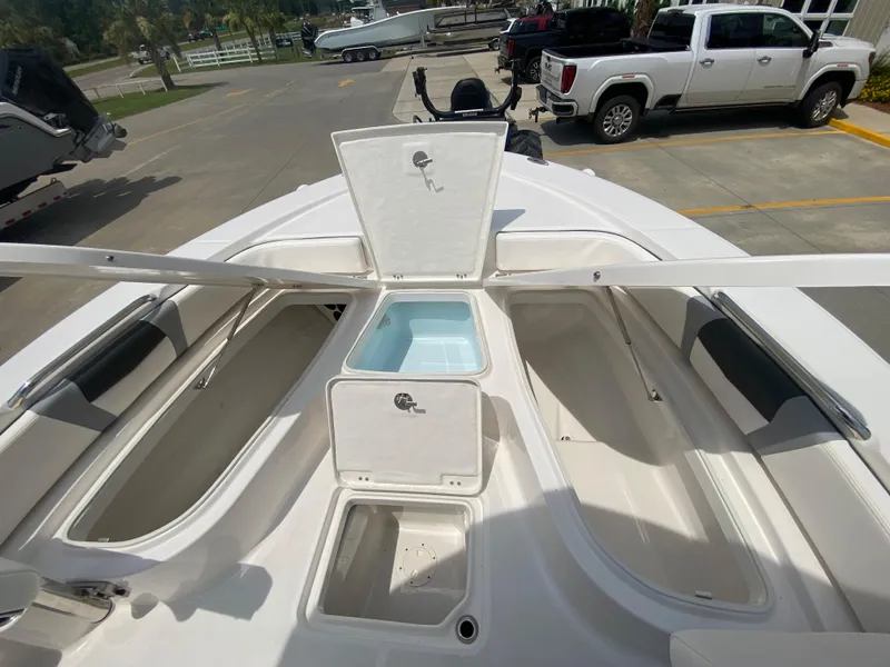 Slide: The Image of 2024 Robalo 226 Cayman boat with open storage compartments and livewell. - 19