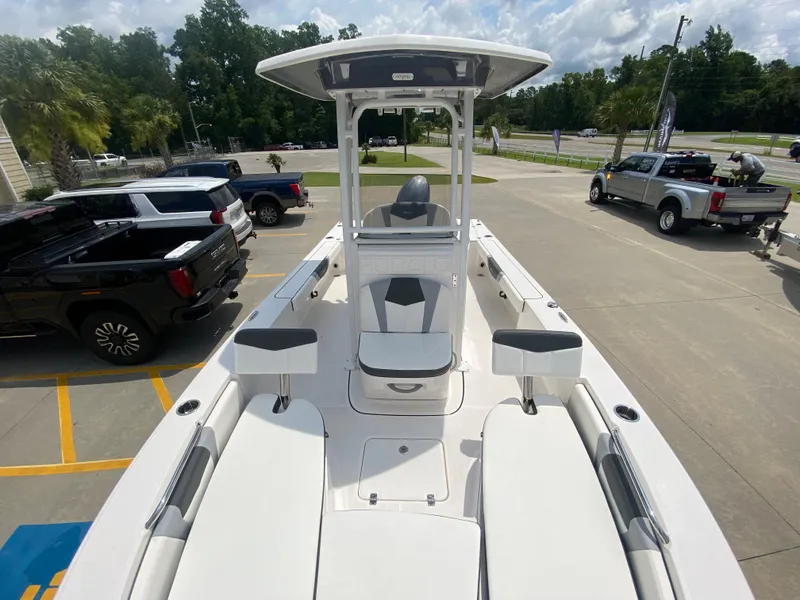 Slide: The Image of 2024 Robalo 226 Cayman boat on display in a parking lot. - 21