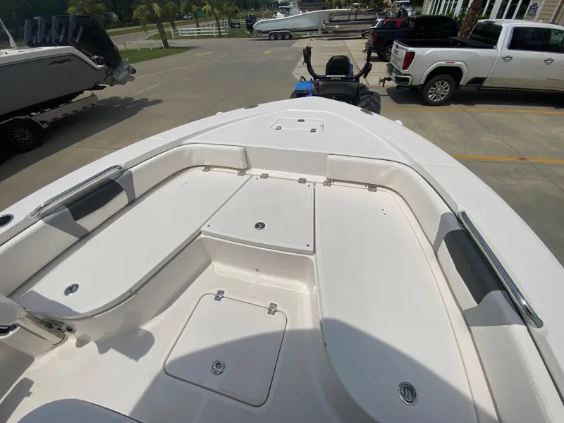 Slide: The Image of 2024 Robalo 226 Cayman boat interior with spacious seating and storage compartments. - 22