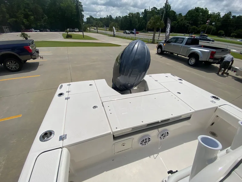 Slide: The Image of 2024 Robalo 226 Cayman boat with outboard motor in parking lot. - 6